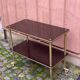 Brown rosewood rolling table with gold fluted legs