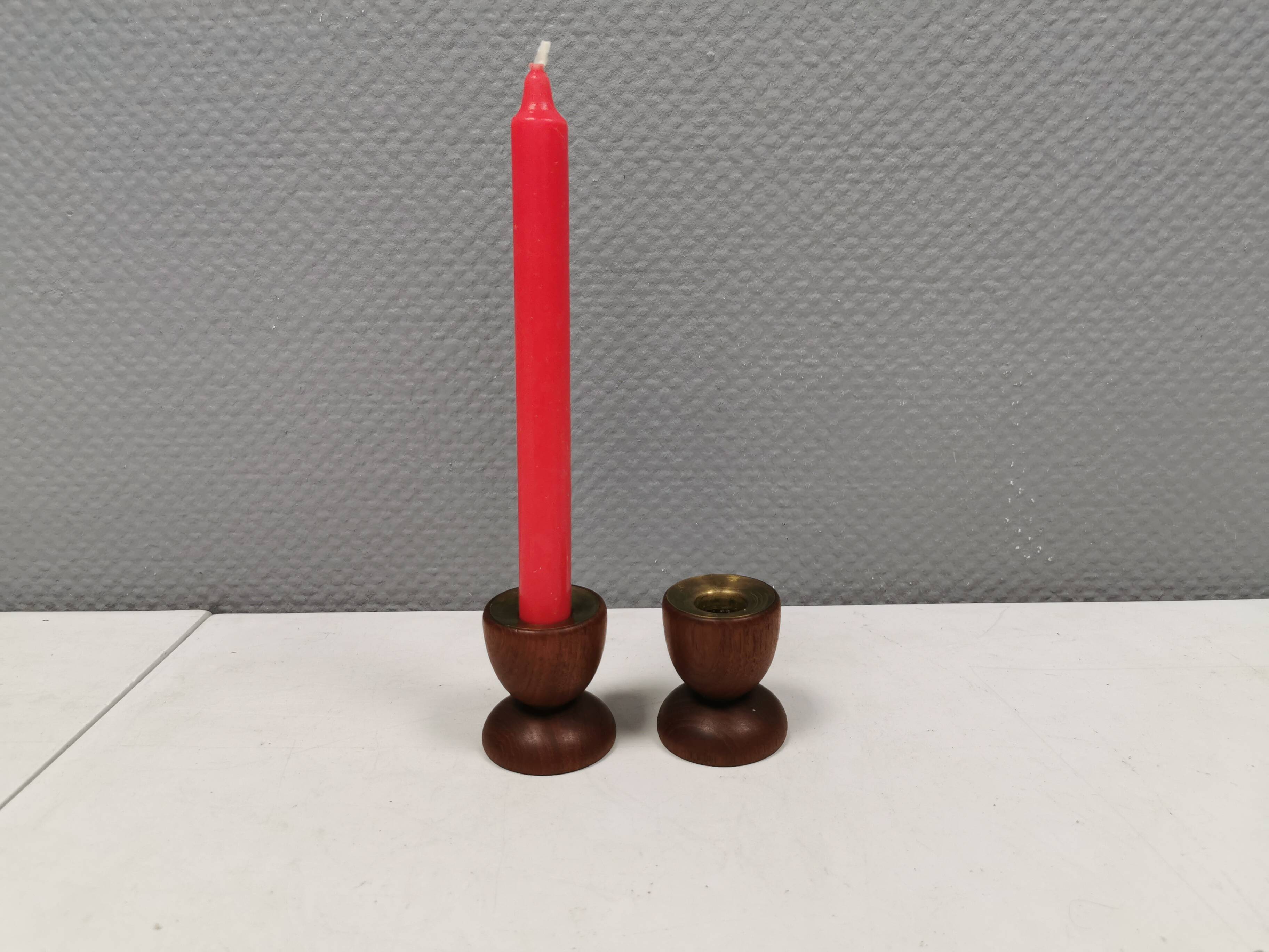 Two beautiful teak candle holders with brass inserts.