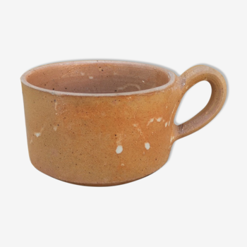 Brown sandstone cup with white spots