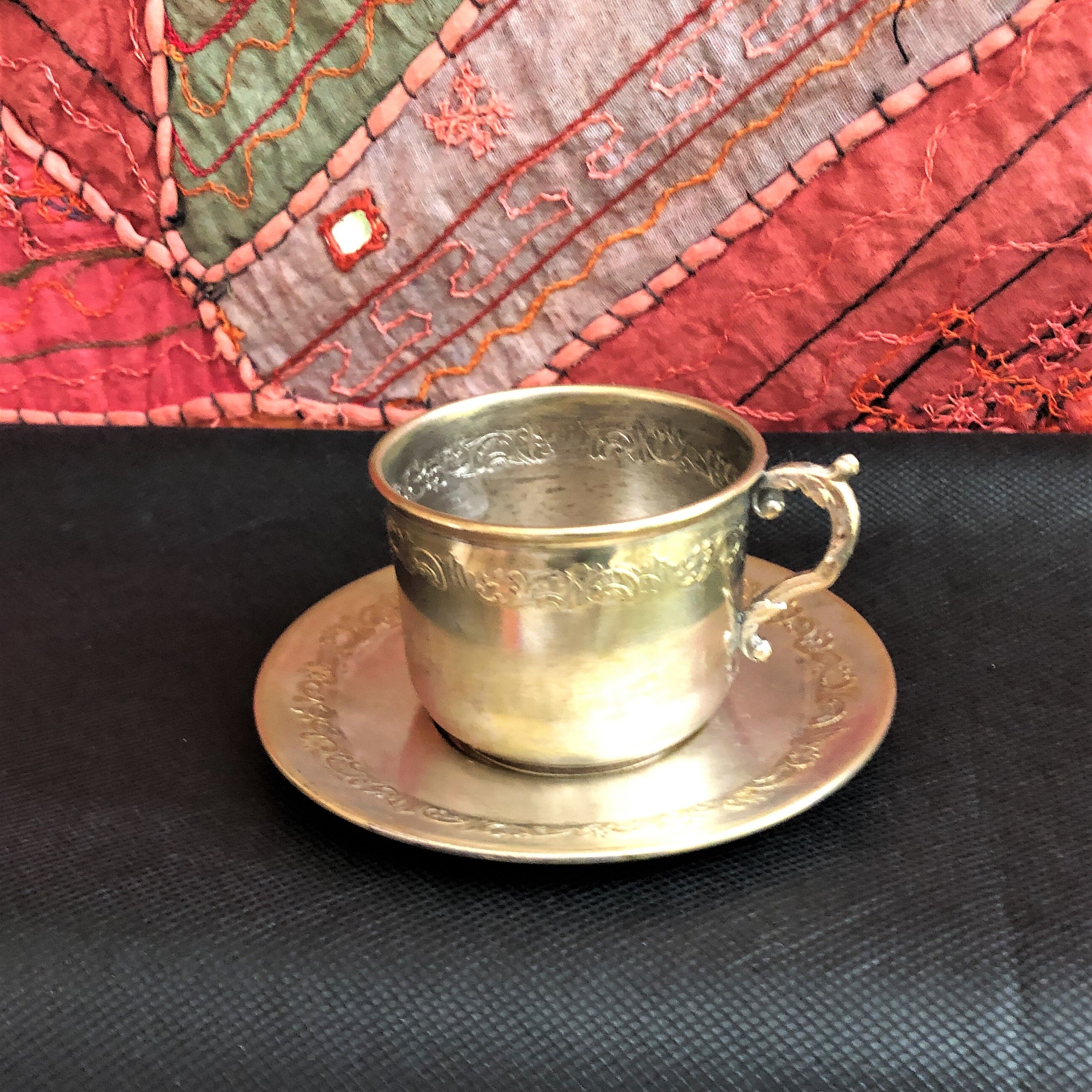 Silver metal cup and saucer