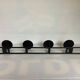 Green black metal coat rack with four hooks