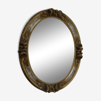 Oval wall mirror, golden floral pattern in stucco and wood, late 19th century