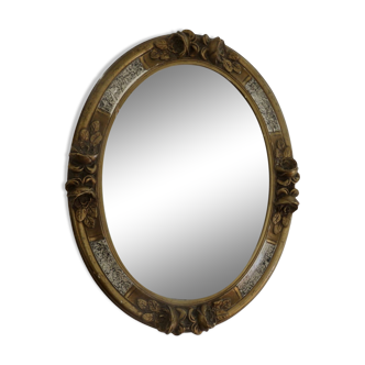 Oval wall mirror, golden floral pattern in stucco and wood, late 19th century