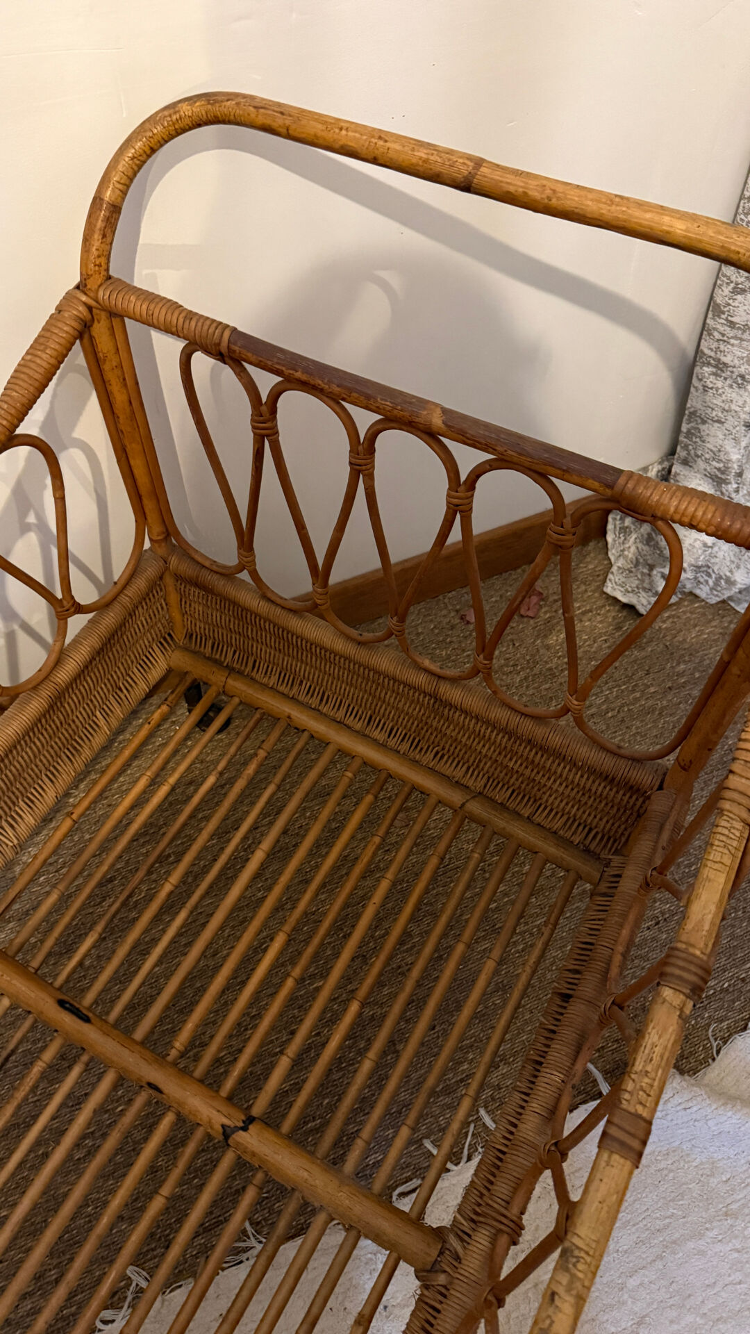 Vintage rattan baby cot on wheels.