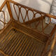 Vintage rattan baby cot on wheels.