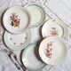 Flat antique earthenware plates with gilded edges