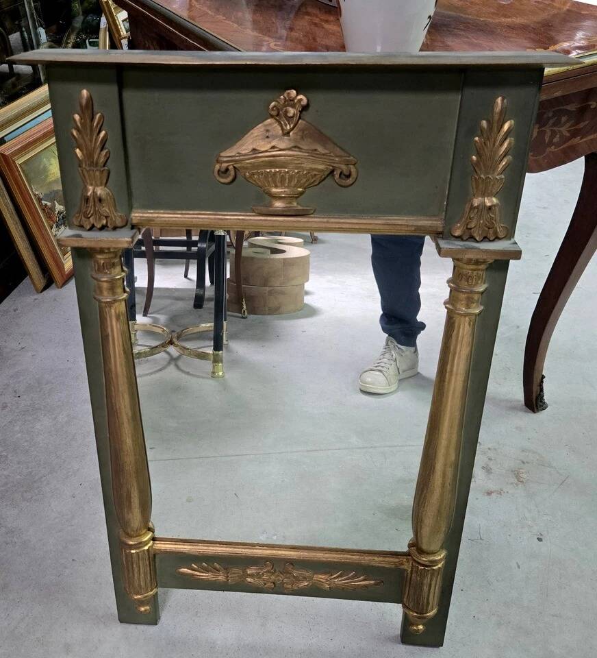 Empire-style mirror in deep green lacquered wood richly enhanced.