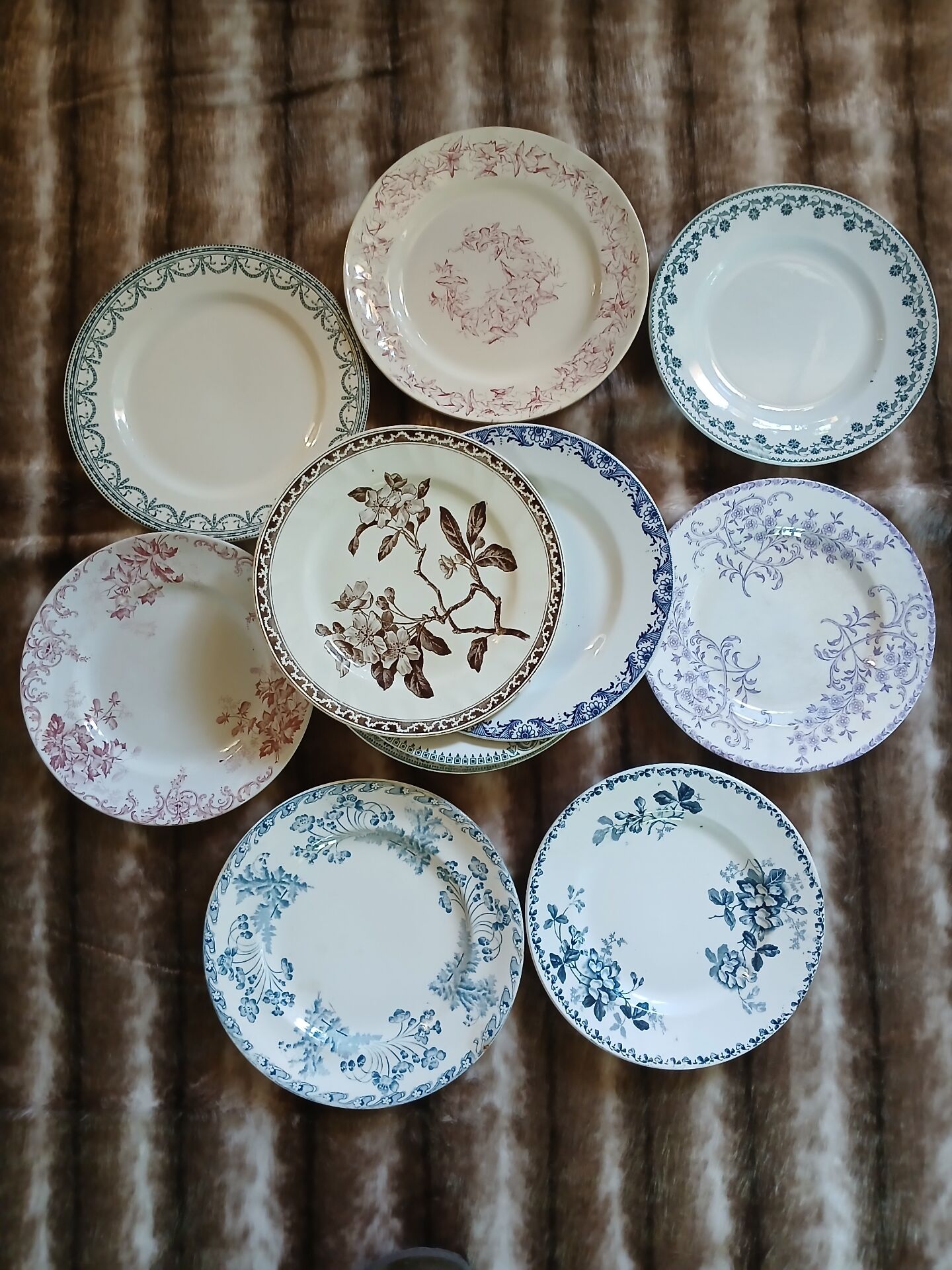 13 mismatched flat plates in ironstone