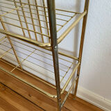 Gilded metal grid shelf in the shape of a vaulted arch