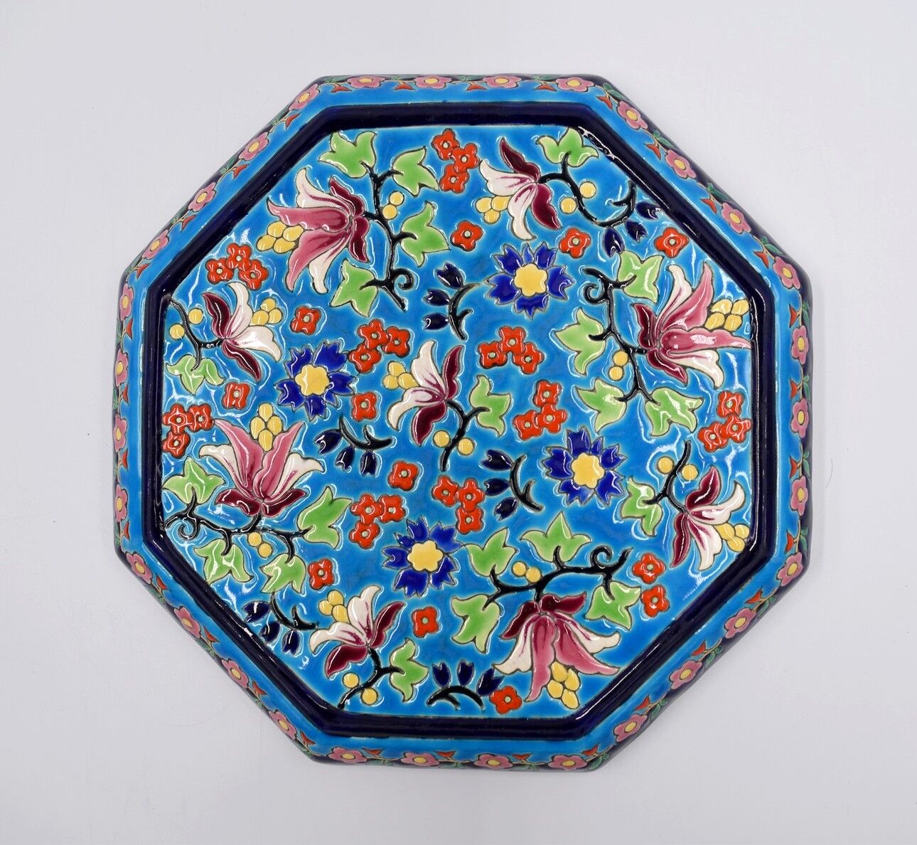 A flat bottom and two enamel bottle bottoms of Longwy