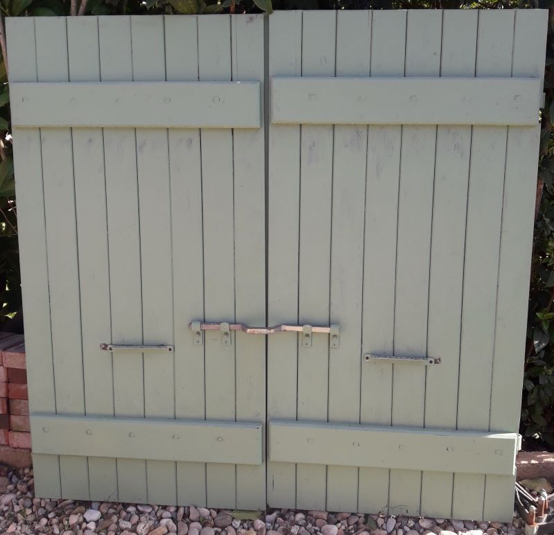 Pair of wooden shutters hanging iron