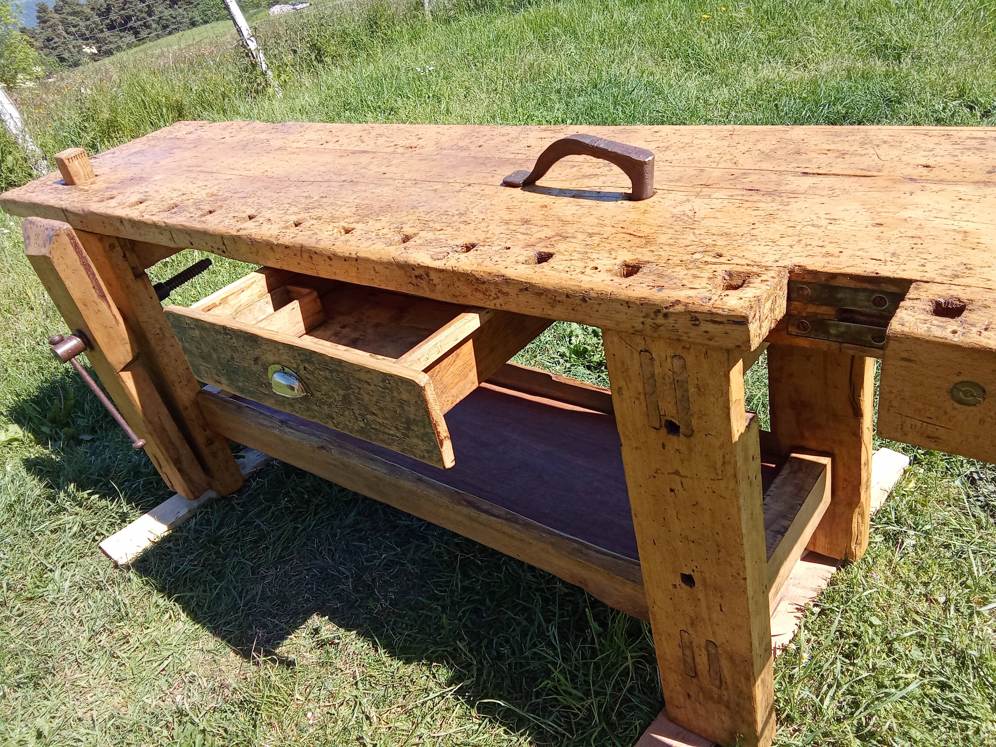 Old solid wood carpenter's bench with 2 functional vices.