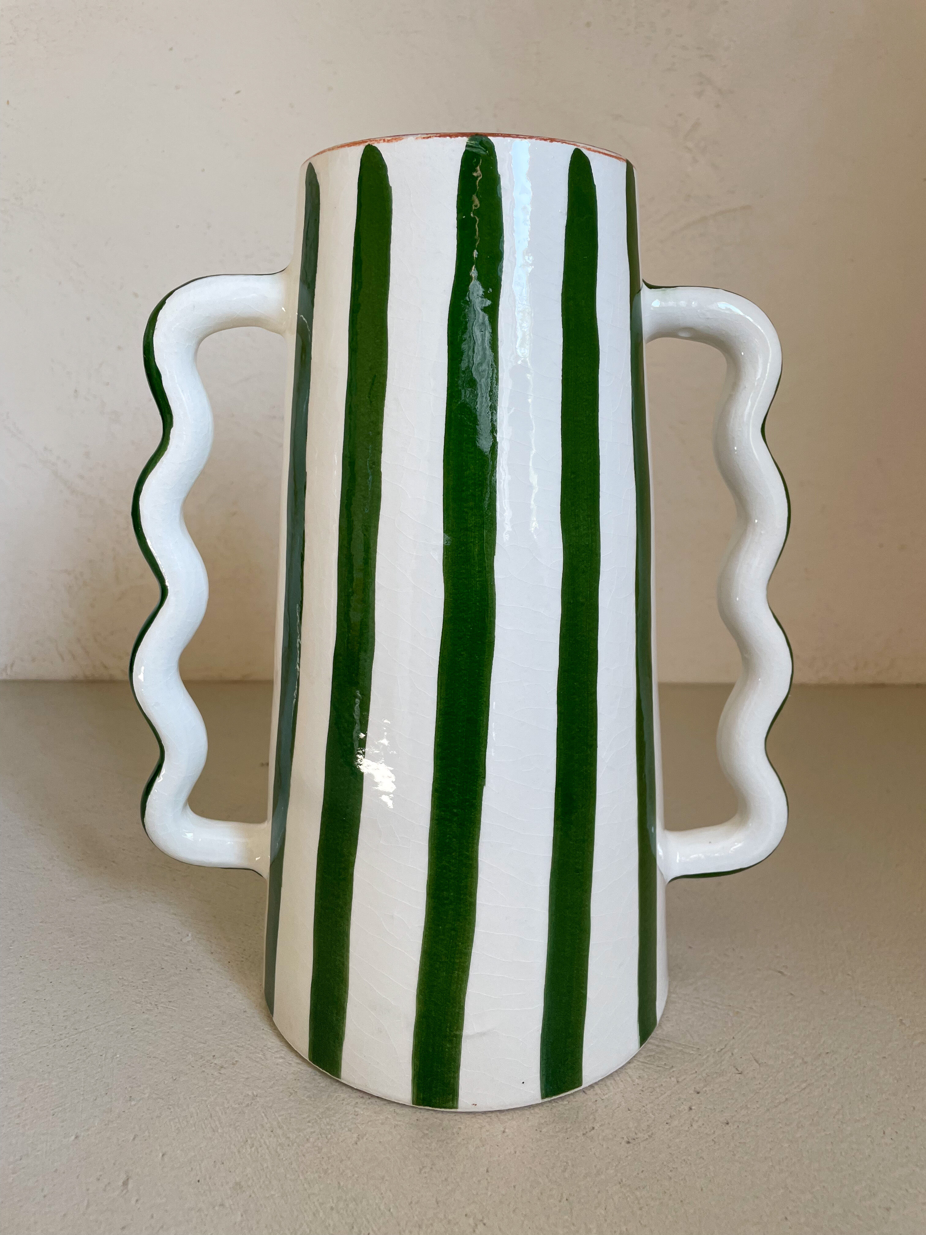 Green and white striped ceramic vase with abstract handmade corrugated handheld