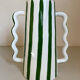 Green and white striped ceramic vase with abstract handmade corrugated handheld