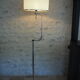 Flexible floor lamp, chrome, opaque white shade with metallic edges.