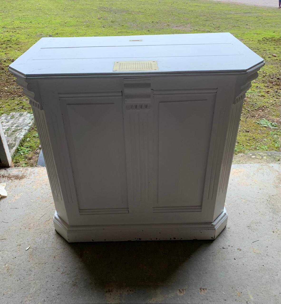White counter with brass coin mechanism