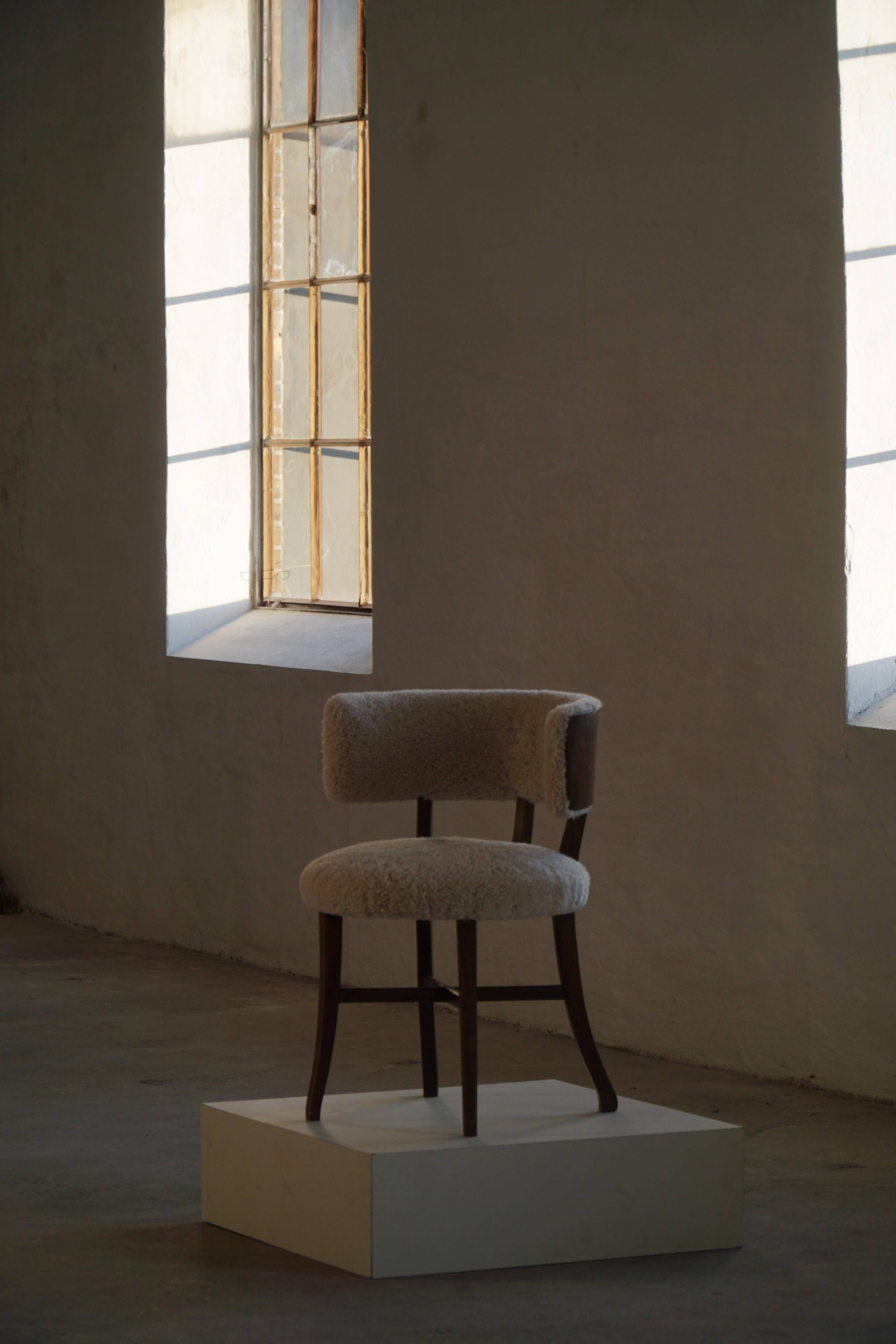 A modern Danish elegant low-back chair, reupholstered in lambswool, 1940s.