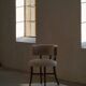A modern Danish elegant low-back chair, reupholstered in lambswool, 1940s.