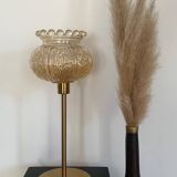 Table lamp with an antique crowned globe and a golden base