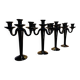 Set of four black glass candle holders.