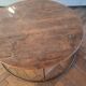Large round coffee table in wood and wrought iron.