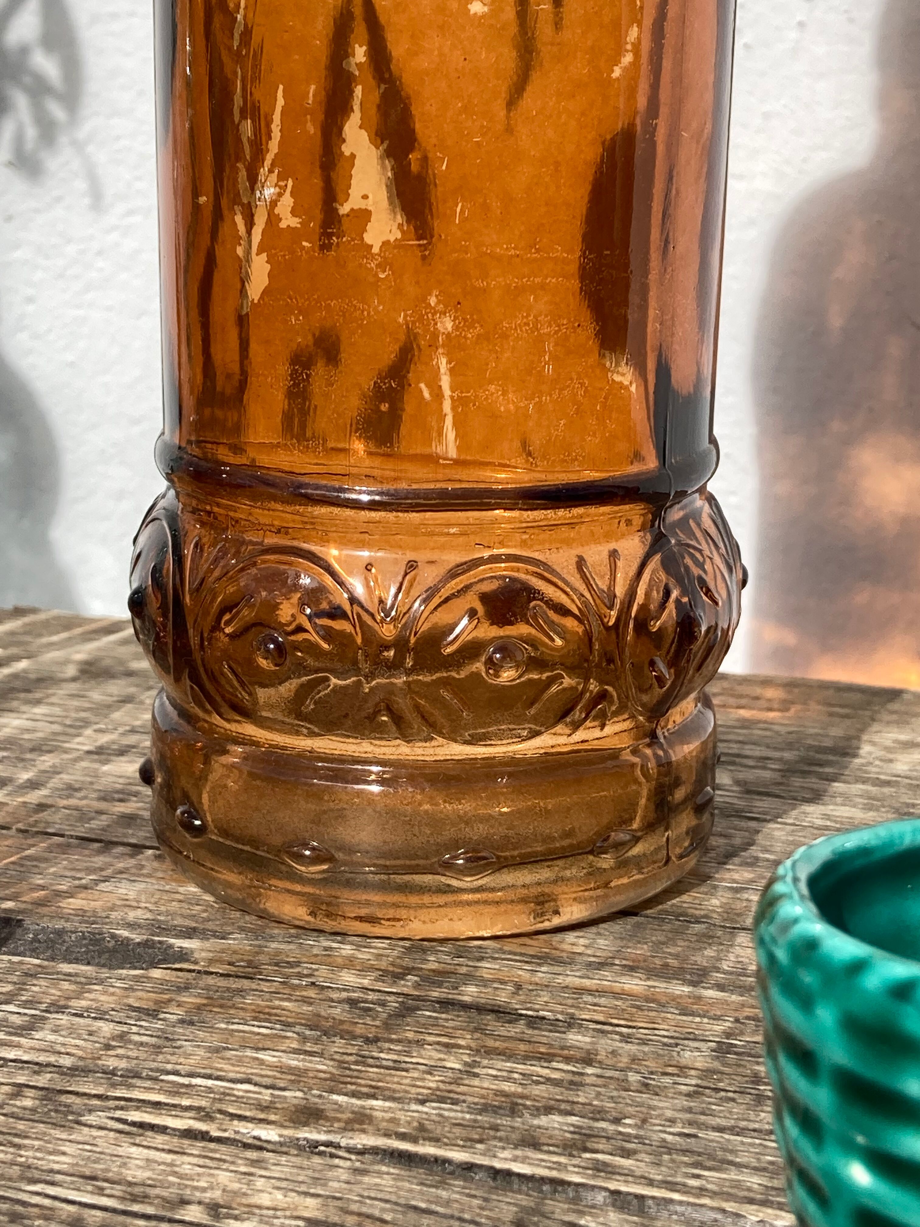 Vintage amber bottle in patterned brown glass
