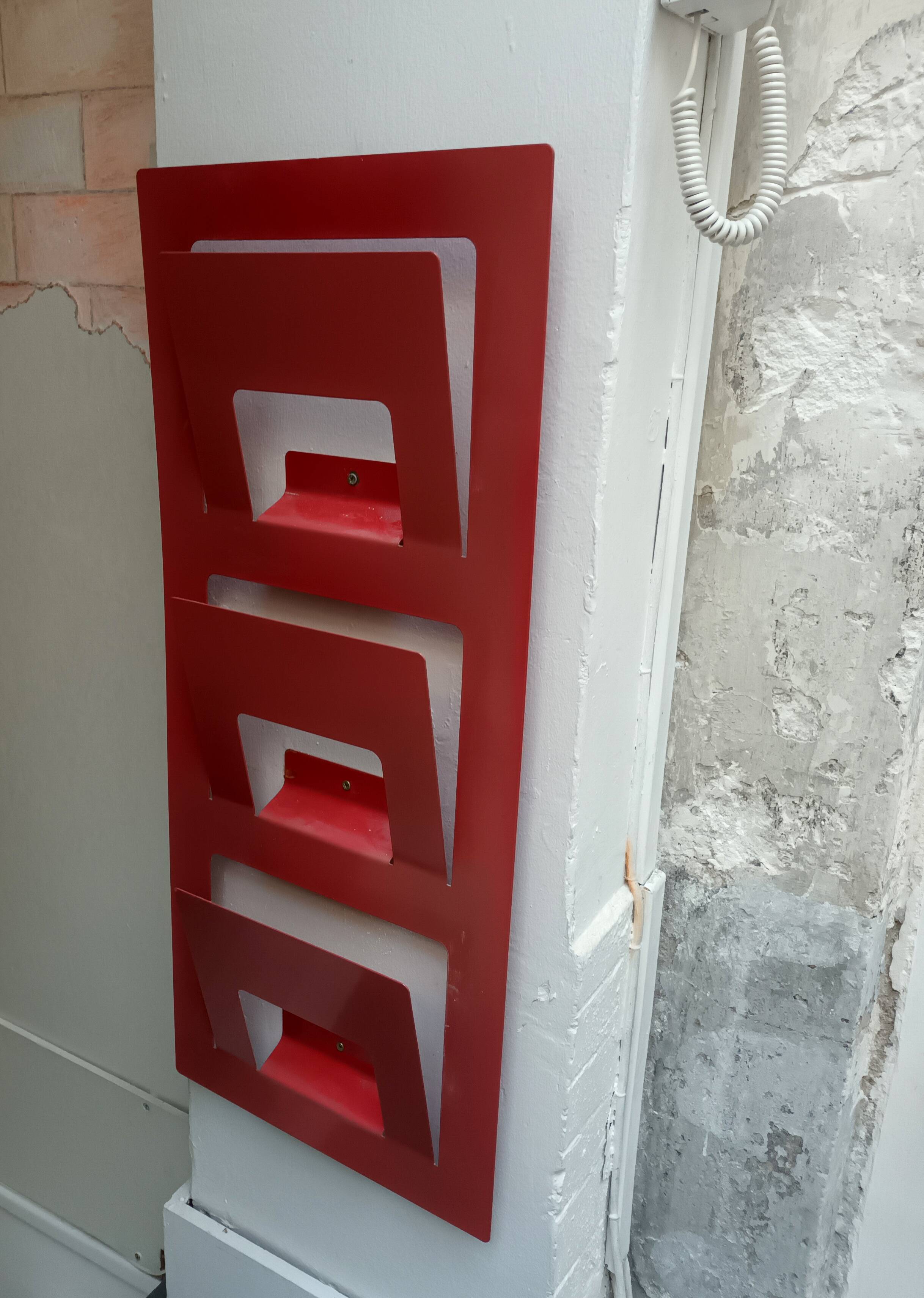 Vintage red metal wall magazine rack