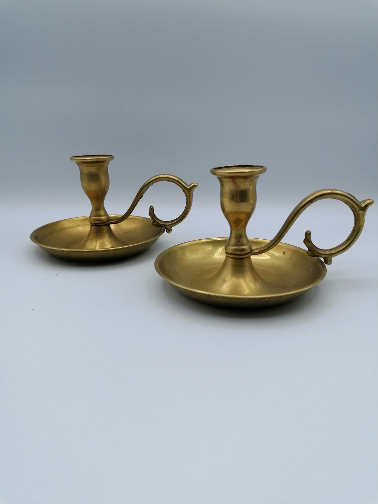 Pair of brass hand candlesticks