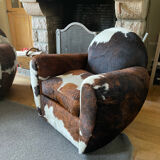 Pair of club chairs covered in cowhide