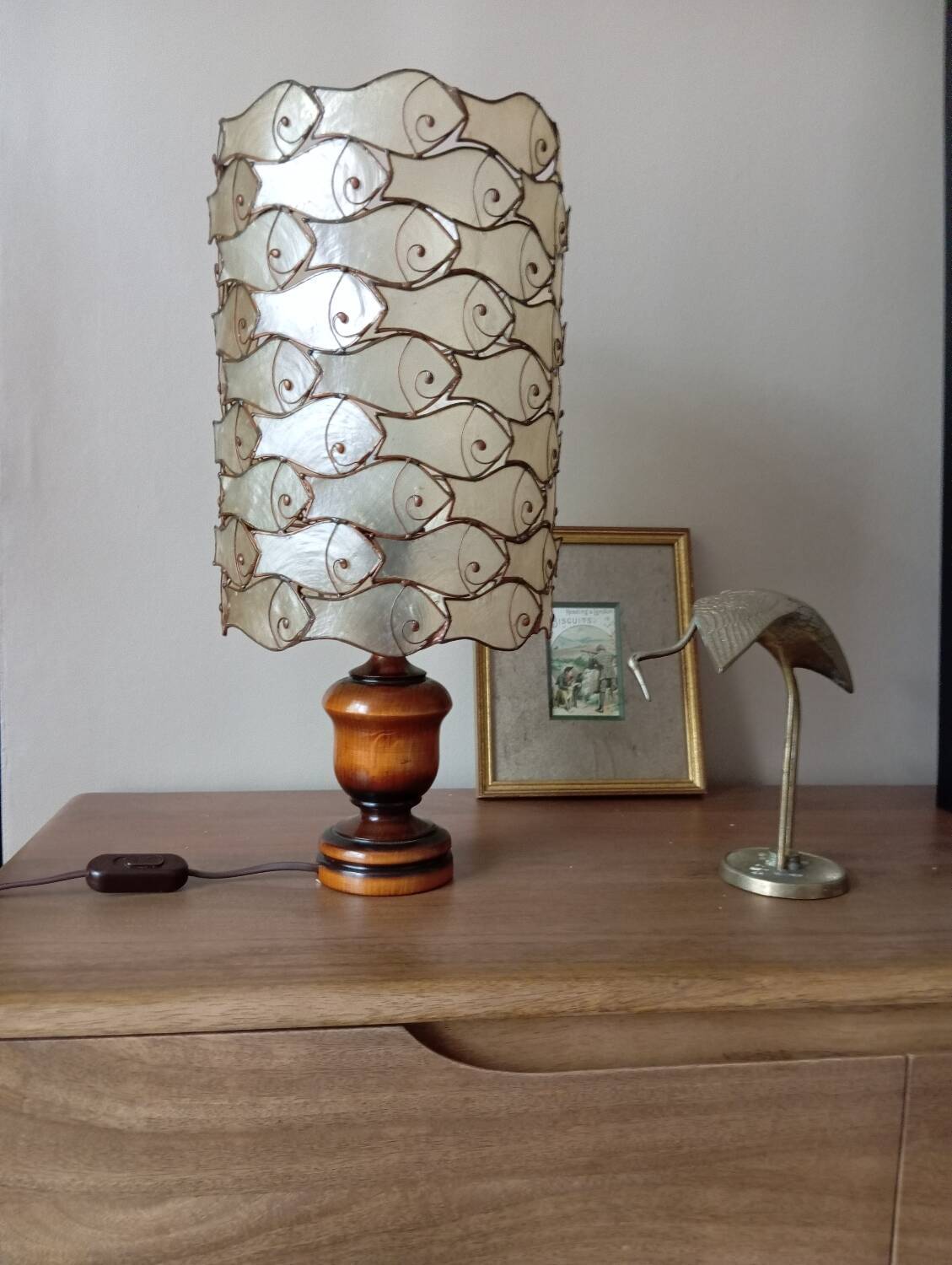 Table lamp with wooden base and mother-of-pearl fish and brass lampshade