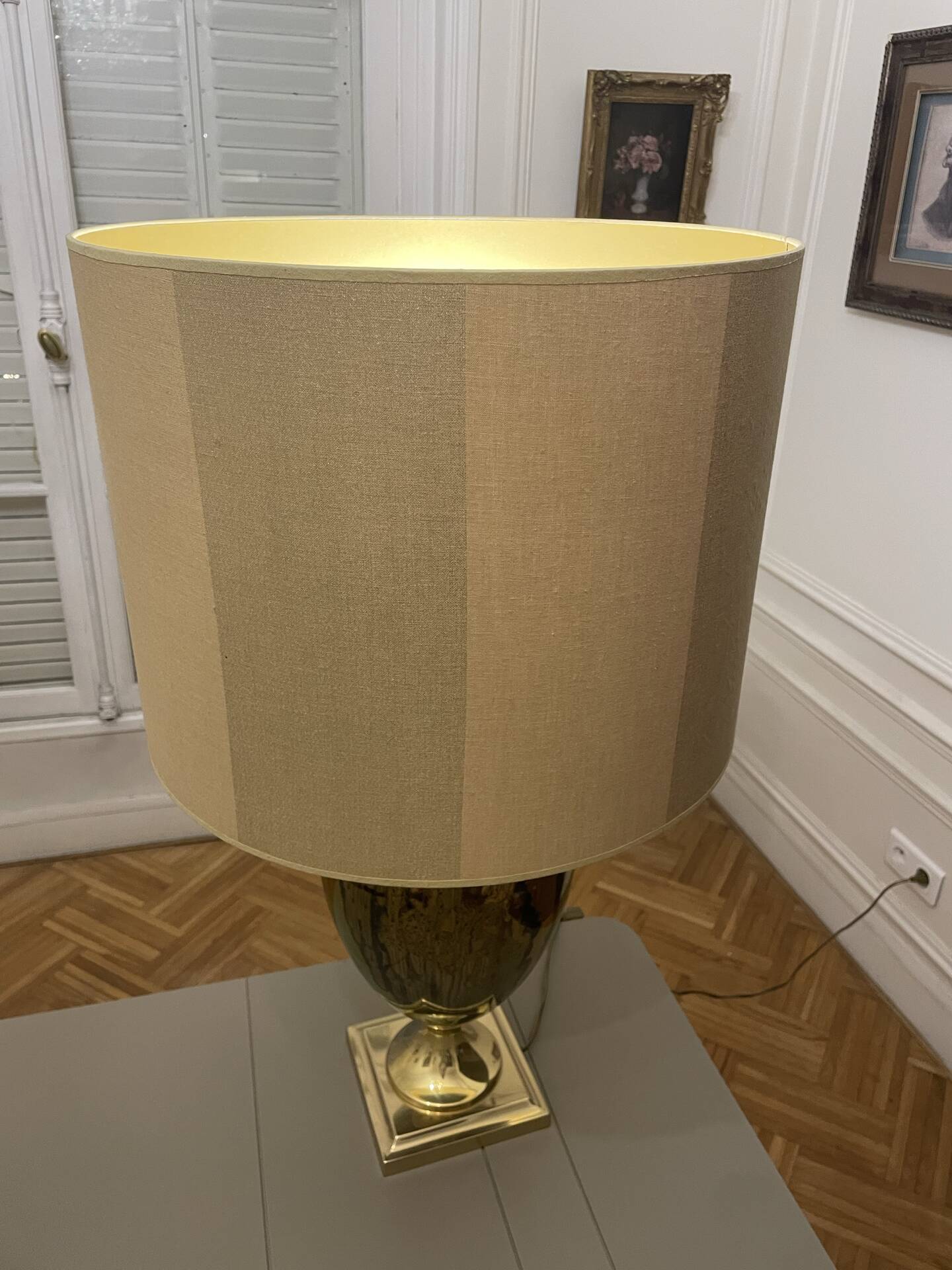 Bronze table lamp with a golden shade.