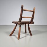 Rustic Wabi-Sabi style accent chair in dark curved hardwood, 1900s.