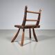 Rustic Wabi-Sabi style accent chair in dark curved hardwood, 1900s.