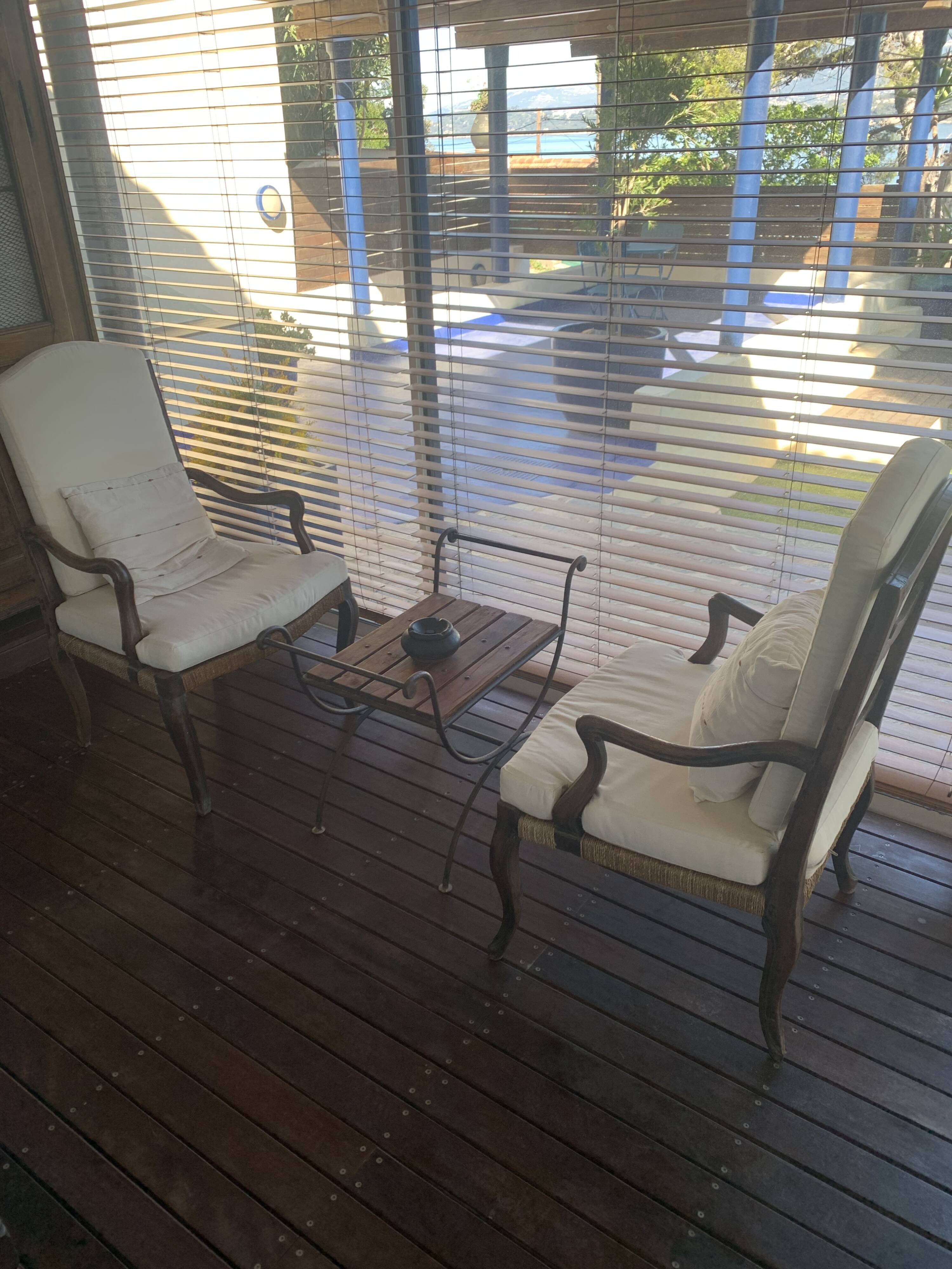 Pair of antique wooden armchairs with woven seats + cushions