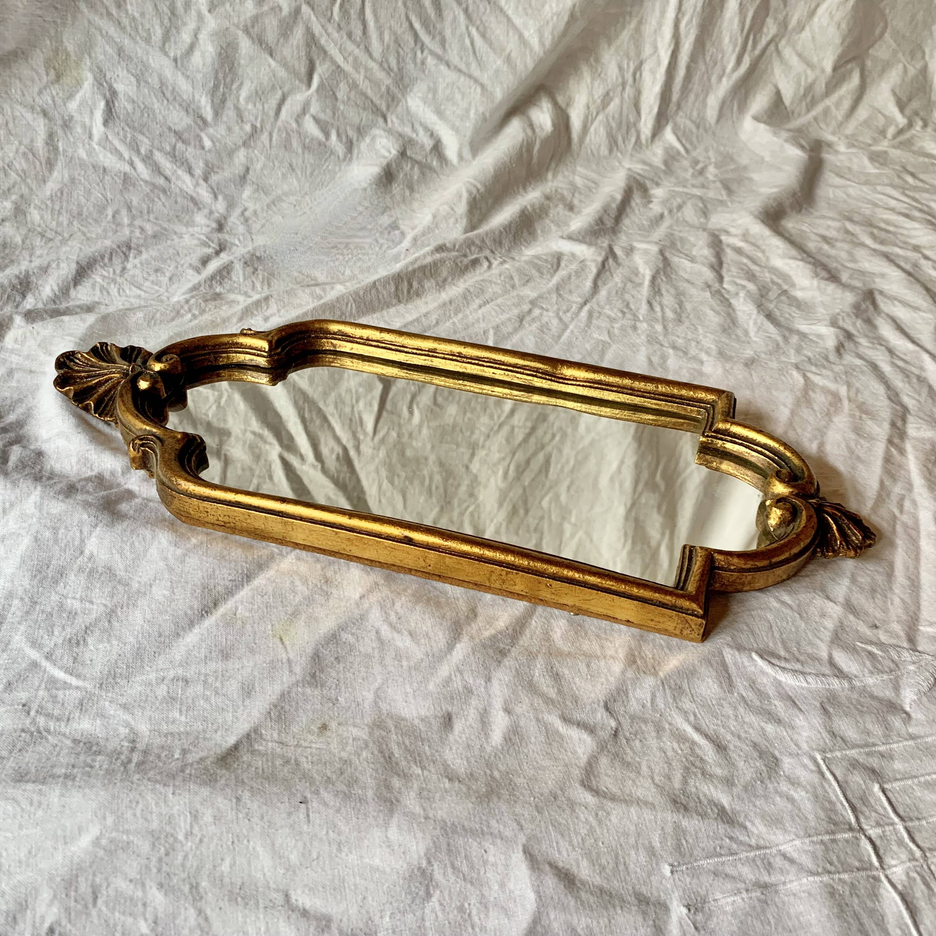 Old small wall mirror in golden resin