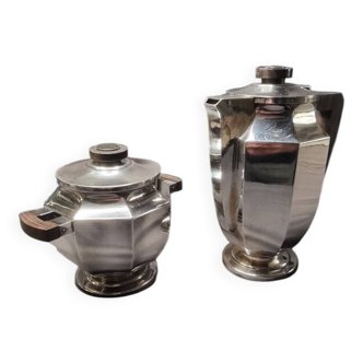 Coffee creamer with a silver metal sugar bowl.