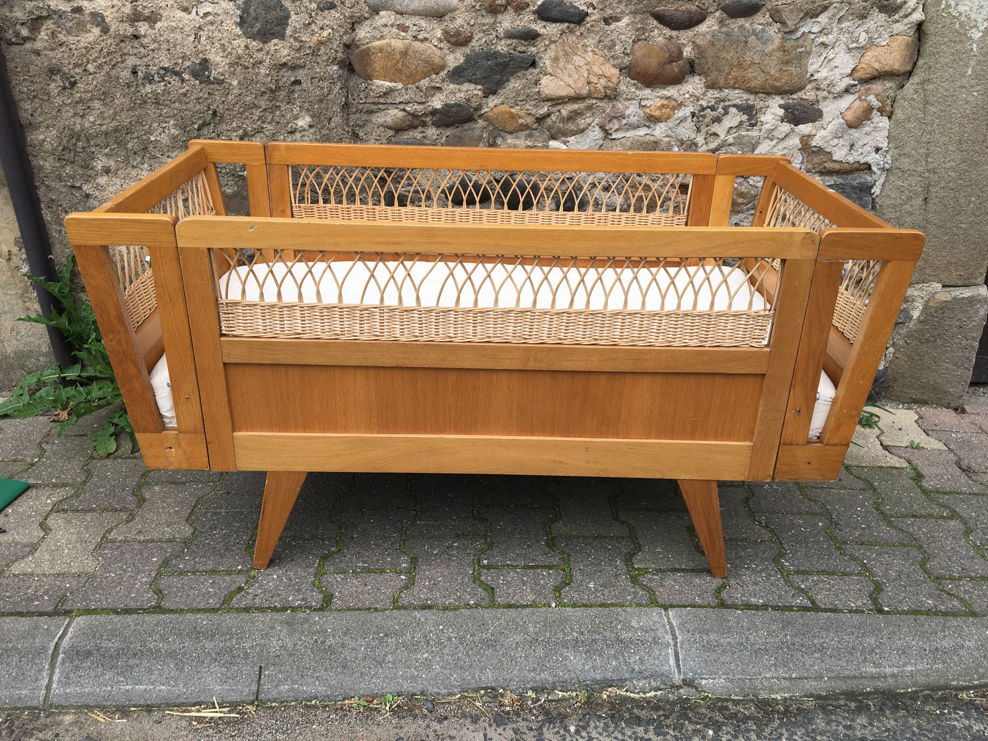 Wooden and rattan baby bed
