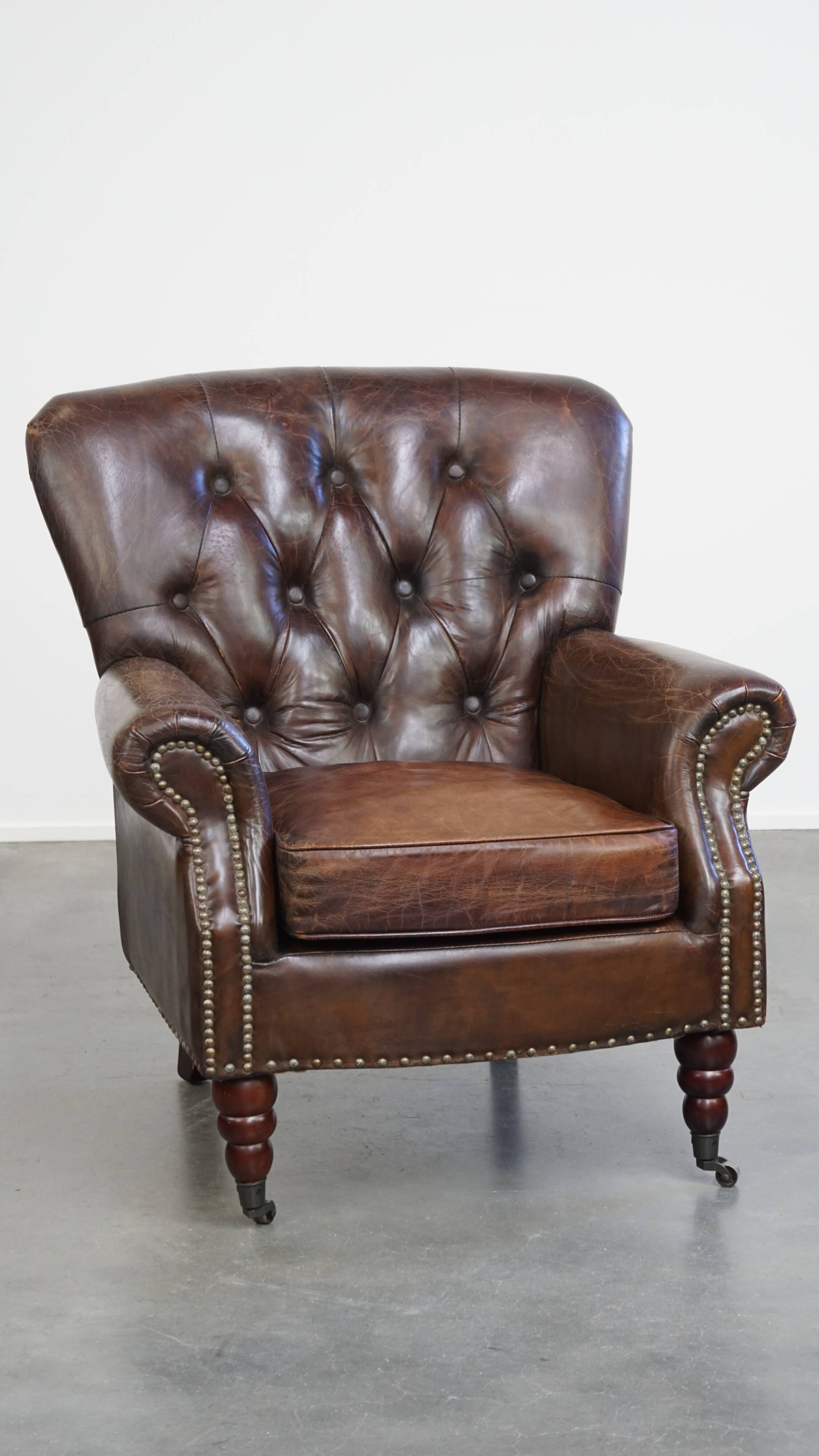 Cognac colored brown grained cowhide chesterfield armchair