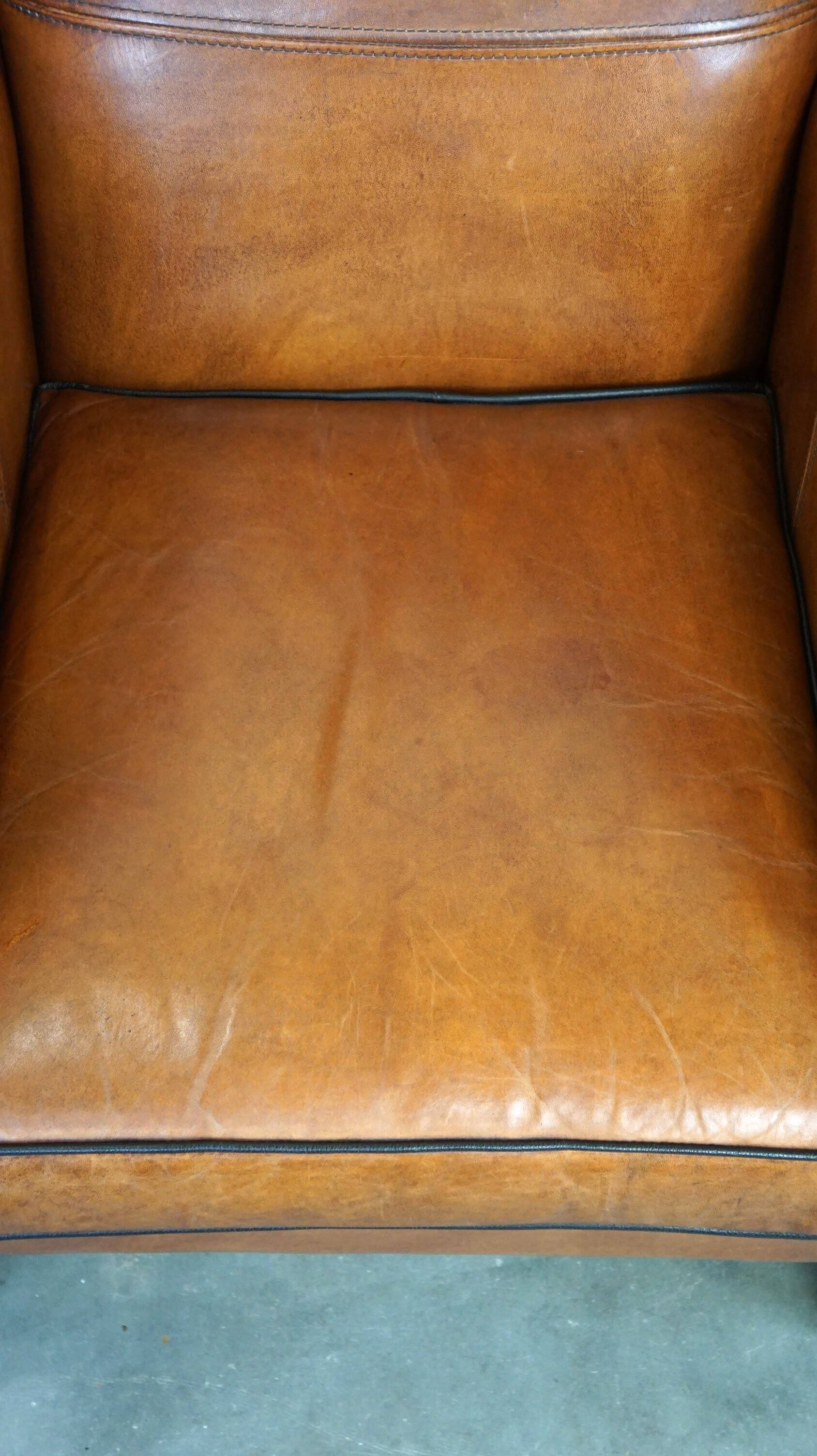 Très beau fauteuil à oreilles en cuir de mouton avec des détails époustouflants