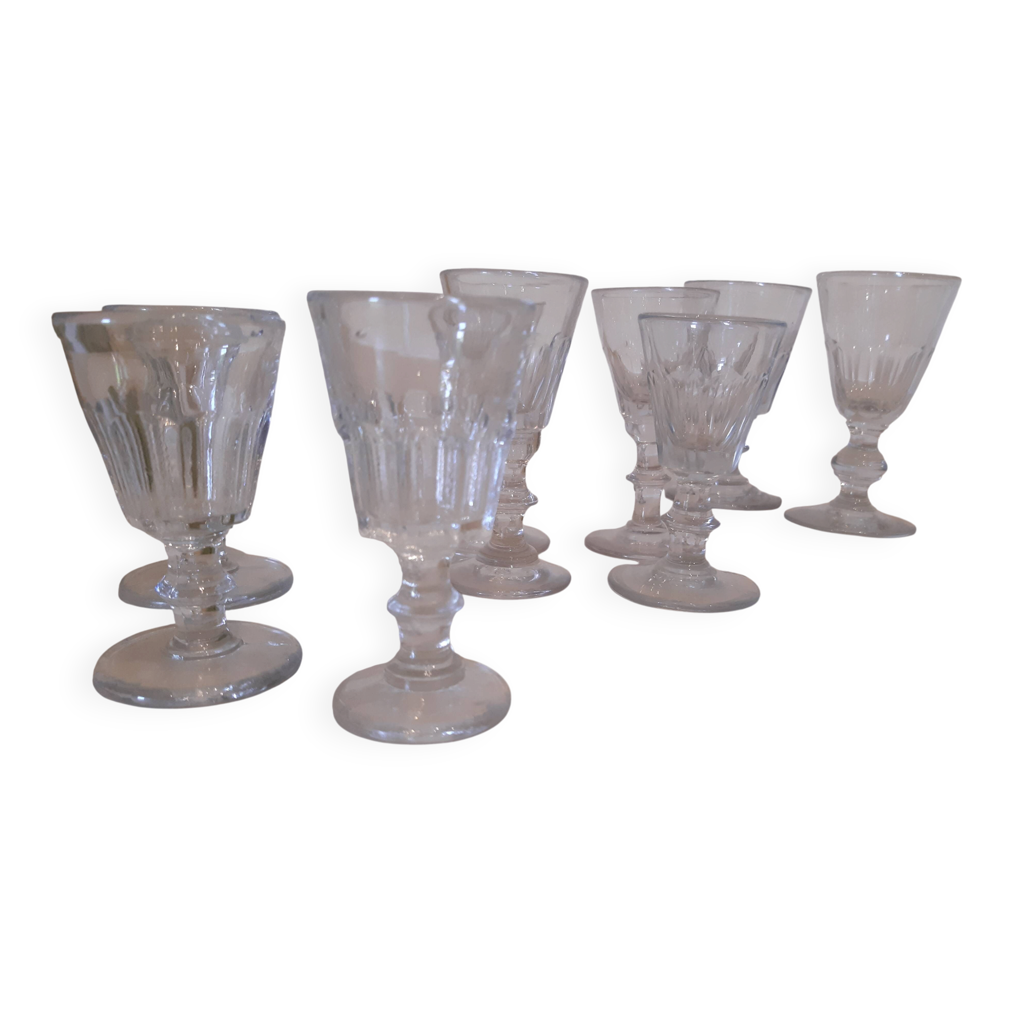 Set of 9 small cut glass stemmed glasses from the 1930s, in various sizes.