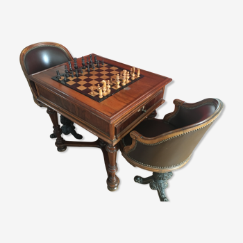 Play table with late 19th century mechanism and pair of leather boat chairs in bronze footings