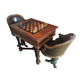 Play table with late 19th century mechanism and pair of leather boat chairs in bronze footings