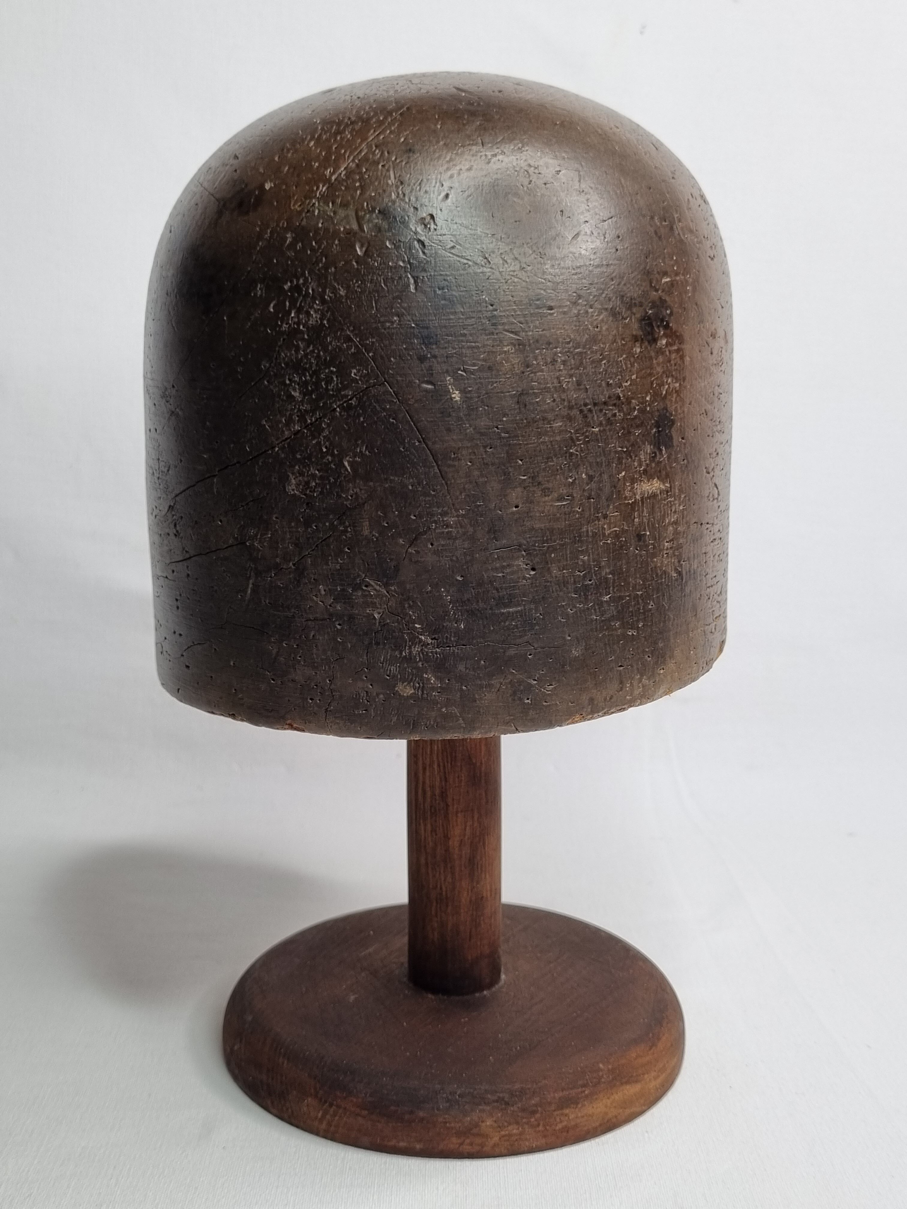 Old solid wood hat shape on foot, 1900