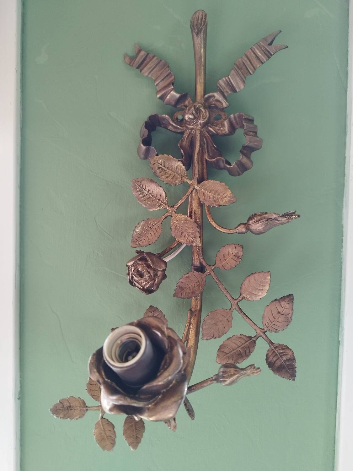 Bronze and gilded metal wall sconce in Louis XVI style.