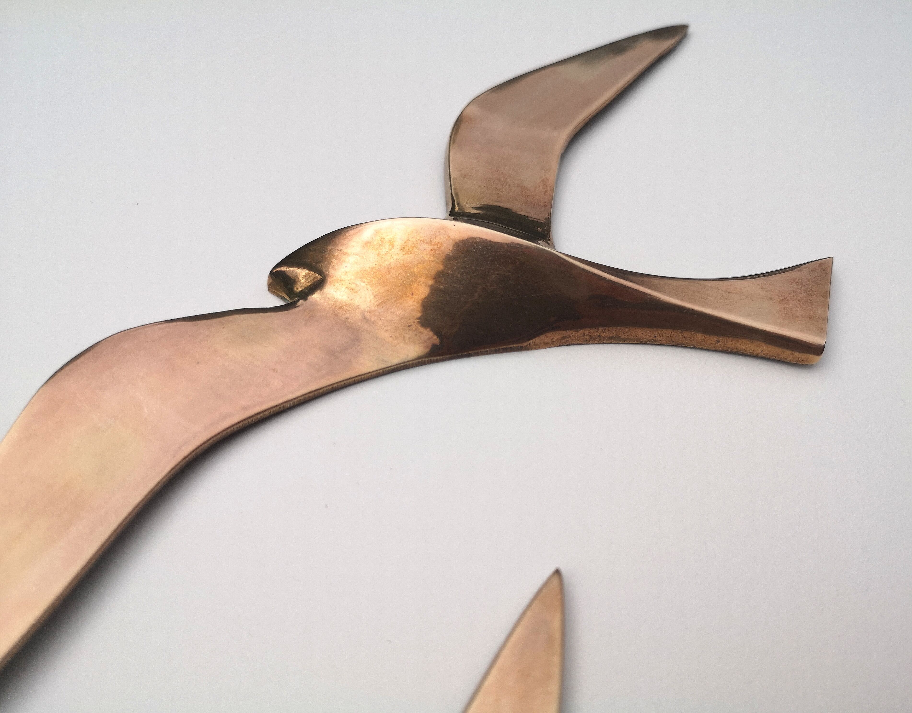 Birds stylized in brass