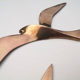 Birds stylized in brass