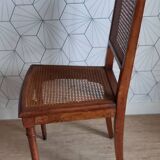 Chaise cannée art déco avec ornements en bronze.