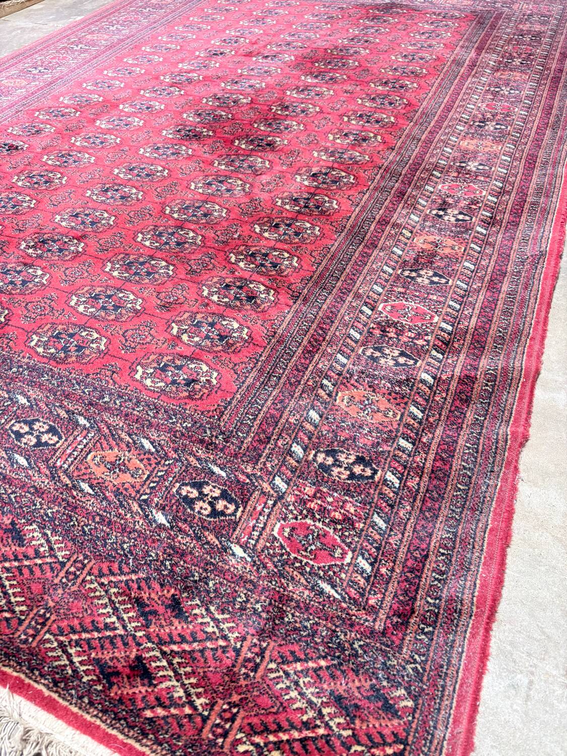 Large red Bokhara-style oriental carpet 300x200 cm with gul patterns.