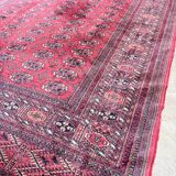 Large red Bokhara-style oriental carpet 300x200 cm with gul patterns.