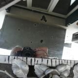 Beveled mirror with art-deco wrought iron frame and floral decor with hanging chain